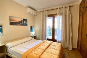 a bedroom with a large bed and a window at Bahia Azul Denia VyB in Denia