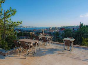 a group of tables and chairs on a balcony at Yeşim Suit Otel in Istanbul