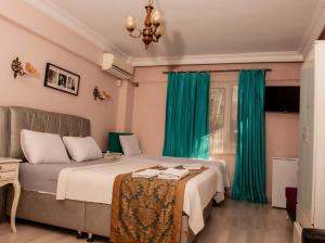 a bedroom with a bed and green curtains at Yeşim Suit Otel in Istanbul