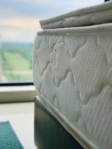 a mattress sitting next to a window on a train at Cozy Hyve Soho Suites in Cyberjaya