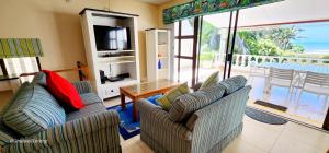 a living room with two couches and a television at Seanique - sleeps 8 in Margate