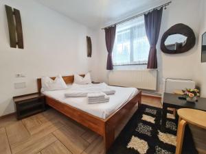 a bedroom with a bed and a table and a window at CABANA FRAM VÂRTOP in Vartop