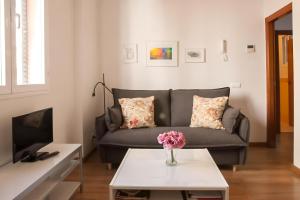 a living room with a couch and a table at Malhara in Seville