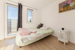 Zidanica med Trtami في Dvor: غرفة نوم بيضاء بها سرير ونافذة