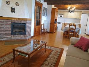 a living room with a couch and a fireplace at Casa Rural ERTEIKOA - Selva de Irati in Aria