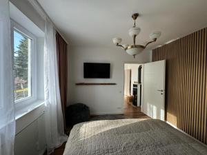 a bedroom with a bed and a large window at Chalet Weiß in Mönichkirchen