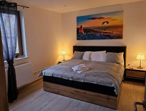 a bedroom with a bed with two towels on it at Haus Martina in Poppenhausen