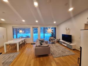 a living room with a table and a couch at Villa Arctic Light in Rovaniemi
