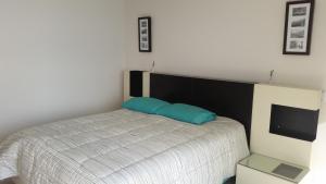 En eller flere senge i et værelse på Apartment Cerro Colorado + 19 billeder