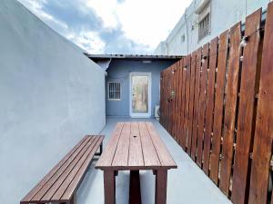a wooden bench sitting in the hallway of a building at Kenting Original Hostel in Kenting
