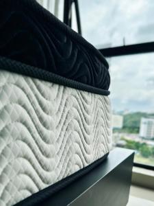 a mattress sitting on a shelf next to a window at Cozy Hyve Soho Suites in Cyberjaya