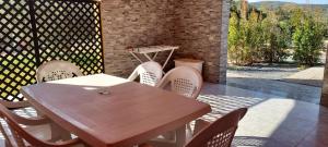 a wooden table and chairs on a patio at LA ROSA DEI VENTI ACCOMADACION in Chia