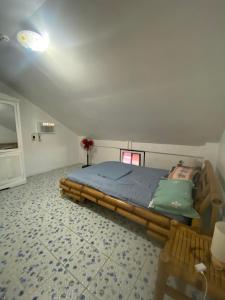 a bedroom with a bed and a table in it at Koa's Beach House in Tangalan