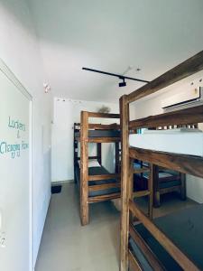 a room with two bunk beds and a hallway at Cliff & Coral in Varkala