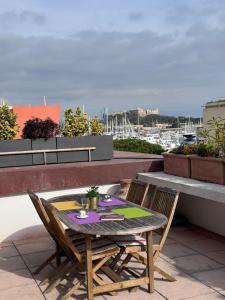 a table and chairs sitting on a roof at Penthouse - Jacuzzi - Terrace - Parking - 2 pools in Antibes