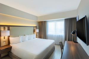 a hotel room with a large bed and a desk at Fairfield by Marriott Los Cabos in Cabo San Lucas