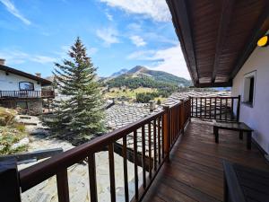 a balcony with a view of a mountain at Hostdomus - Chalet Sun in Sestriere