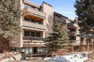 a large building with snow in front of it at Luxurious 2 BR, 2 BA - Aspen Core in Aspen