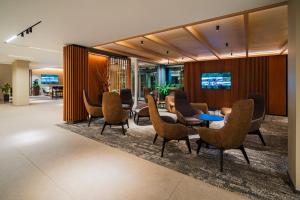 a lobby with chairs and a table in a building at OREA Resort Sklář Harrachov in Harrachov