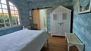 a bedroom with a bed and a window and a door at Maison "Sarah Bernhardt" in Andernos-les-Bains