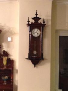 a grandfather clock hanging on the corner of a wall at VERA’S APARTMENT in Markopoulo