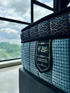 a close up of a suitcase on a train with a window at Cozy Hyve Soho Suites in Cyberjaya