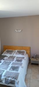 a bedroom with a bed with newspapers on it at Dolce Notte in Saintes-Maries-de-la-Mer +13 photos