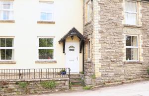 a white brick house with a white door at Pet-Friendly Logburner Horse Stable Views in Hay-on-Wye