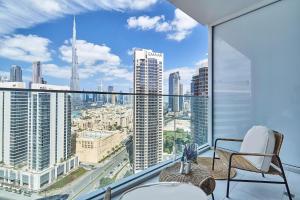 an apartment balcony with a view of a city at Luxury Studios with Burj Khalifa or Canal View in Downtown - Marquise Square Tower in Dubai