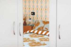 a bedroom with a bed with a striped pillow on it at Sancisi 3 in Santarcangelo di Romagna +5 photos