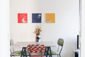 a table with two chairs and a vase on it at Sancisi 3 in Santarcangelo di Romagna