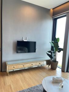 a living room with a flat screen tv on a wall at Penang Amazing SeaView Private Lift 梹城富人区绝美海景公寓私人电梯 in Tanjong Tokong