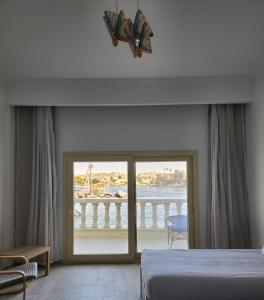 a bedroom with a bed and a view of the ocean at NUB INN in Aswan