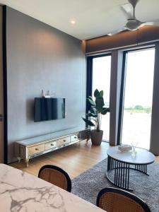 a living room with a flat screen tv on a wall at Penang Amazing SeaView Private Lift 梹城富人区绝美海景公寓私人电梯 in Tanjong Tokong
