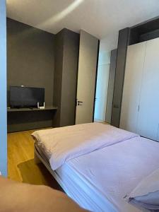 a bedroom with a bed and a flat screen tv at Penang Amazing SeaView Private Lift 梹城富人区绝美海景公寓私人电梯 in Tanjong Tokong