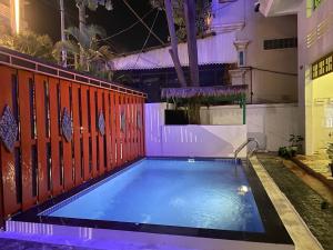 a small swimming pool with a red fence at Centro Guest House in Siem Reap