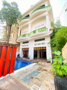 a house with a swimming pool in front of it at Centro Guest House in Siem Reap