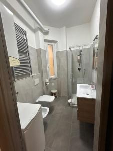 a bathroom with two toilets and a sink and a shower at CASA GIANNINO in Rome