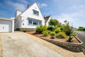 a white house with a driveway at Finest Retreats - Beyond The Blue in Porthleven
