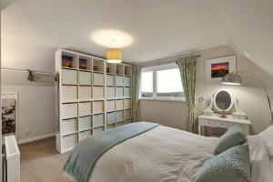 a bedroom with a large bed and a mirror at Finest Retreats - Beyond The Blue in Porthleven