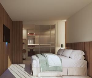 a bedroom with a white bed and a television at Eurosalou & Spa in Salou