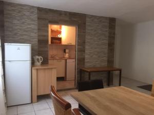 a kitchen with a white refrigerator and a table with chairs at Spitz West in Spitz