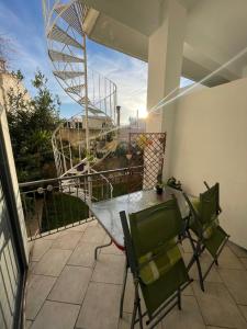 a patio with a table and chairs on a balcony at Barbara's appartment in Athens