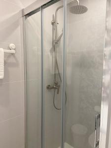 a shower with a glass door in a bathroom at Veuràs el Mar - Madrague Beach apartment 15 in Roses