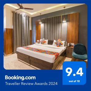 um quarto de hotel com uma cama e uma cadeira em FabHotel Royal Palm Inn em Faizābād