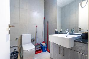 a bathroom with a white toilet and a sink at SuperHost - Comfort 1BR Centurion Onyx Retreat with Balcony in Dubai