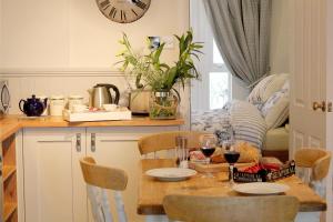 uma cozinha com uma mesa com copos de vinho em Tide House Seaside Holiday Cottage em Shaldon