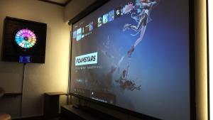 a large screen with a video game on it at Cinema Resorts 1 in Motobu