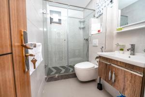 a bathroom with a shower and a toilet and a sink at Maarif elite suites in Casablanca
