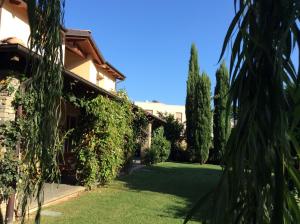 a garden with trees and a building at Villa Marlene B&B in Albenga